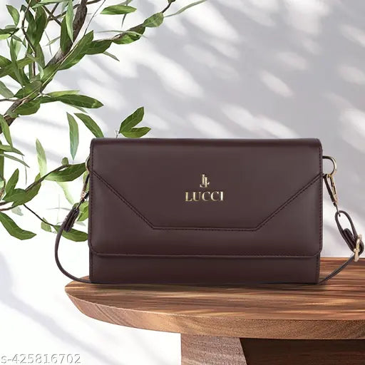Black leather sling bag with long strap, gold logo
