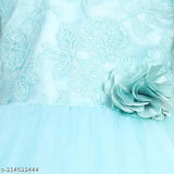 A child's dress in sky blue with a floral embellishment at the bodice