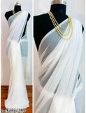 White traditional sari with pallu, adorned with pearl necklace