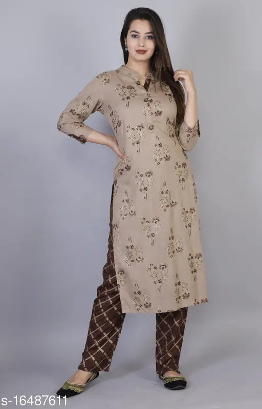 Women's printed brown rayon kurta pant set with three-quarter sleeves, Indian traditional wear on display rack