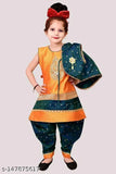 Green and blue lehenga with puffy sleeves, adorned with a bindi on forehead