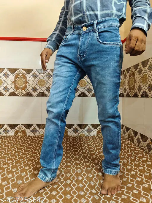 Dark blue denim jeans with rolled up legs and cuffs