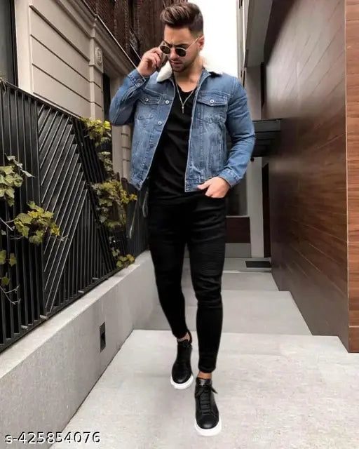 Man in black sunglasses walking down street in black jeans, paired with gray t-shirt