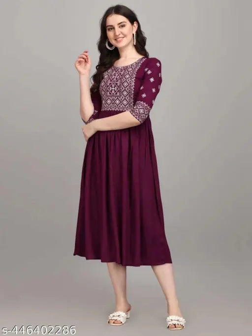 Purple embroidered viscose rayon A-line kurta with three-quarter sleeves, handcrafted Indian women's clothing on mannequin