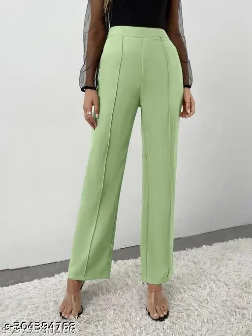 The image displays a pair of women's trousers in a light green or mint color, featuring high-waisted designs with a button and zipper closure, and what appears to be pockets on the front. They are displayed against a neutral background