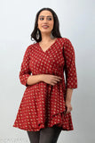 A woman in a red and navy blue patterned kurta