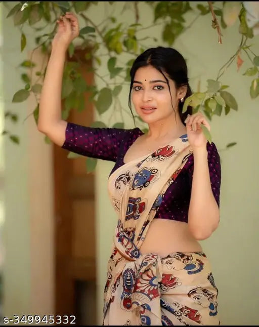 Woman in a printed sari, smiling and waving