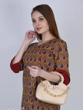 Woman in printed top holding a sling bag, possibly carrying a white wallet