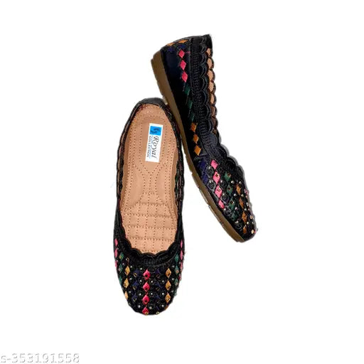 Black, embroidered, multi-belly slip-on flat shoes with a single strap across the foot