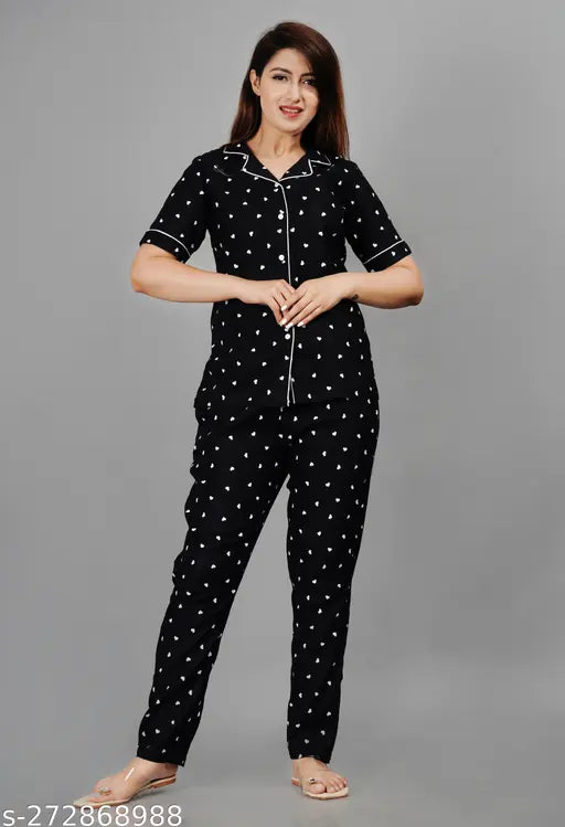 Black rayon printed women's nightsuit set with short sleeves and matching bottom, featuring intricate patterns on both top and pyjama. Available in sizes M-XXXL