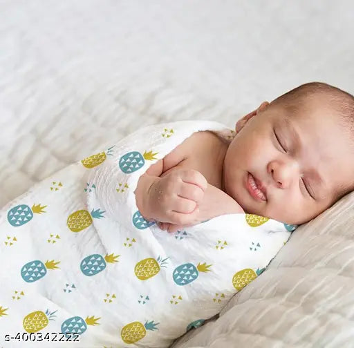 White muslin swaddle with pineapple print, organic cotton for newborn baby.