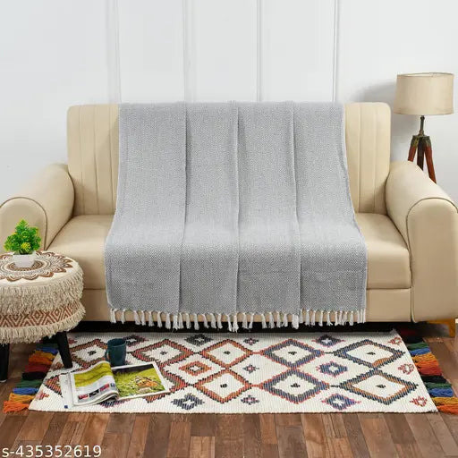 Grey and white herringbone pattern throw blanket on couch