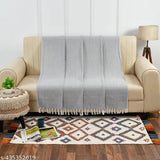 Grey and white herringbone pattern throw blanket on couch