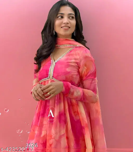 Peach georgette gown with long sleeves, fitted waist and flared skirt