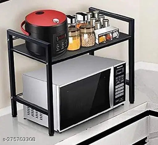 Black metal shelf with two shelves, holding microwave and oven, kitchen storage solution