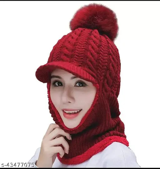 The woman is wearing a red knitted beanie and scarf set