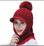 The woman is wearing a red knitted beanie and scarf set