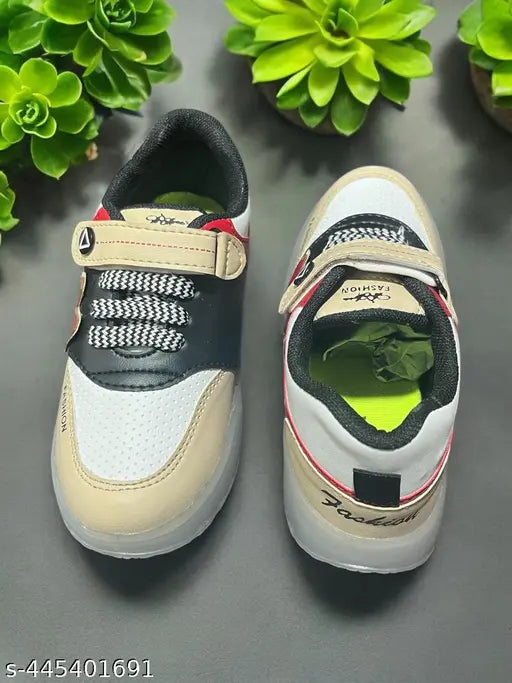 Trendy white and black kids sneakers with red stripes and adjustable velcro straps