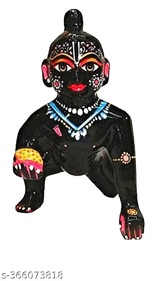 Black ceramic figurine of Lord Gopal with a small kanha fruit