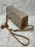 A ladies sling bag in a metallic glitter material