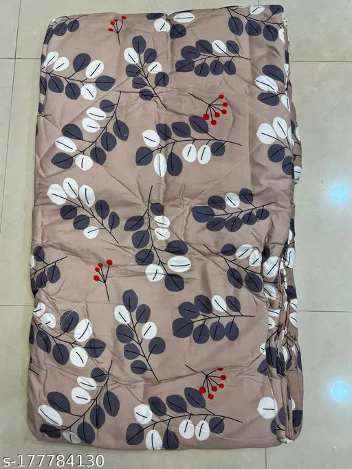 A purple and white flower patterned blanket with a geometric design on it