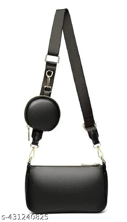 A fancy black leather sling bag with a small circular metal detail and adjustable strap