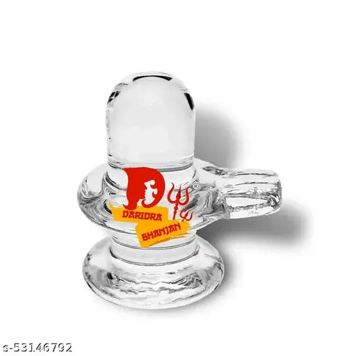 A clear glass shivalingam for pooja, with a red and gold label at the top