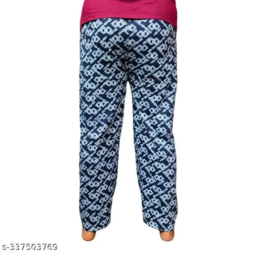 The image features a pair of women's full-length pyjamas in a cotton blend material, presented in a multi-colored design. The pyjamas are styled with a patterned hem and cuffs