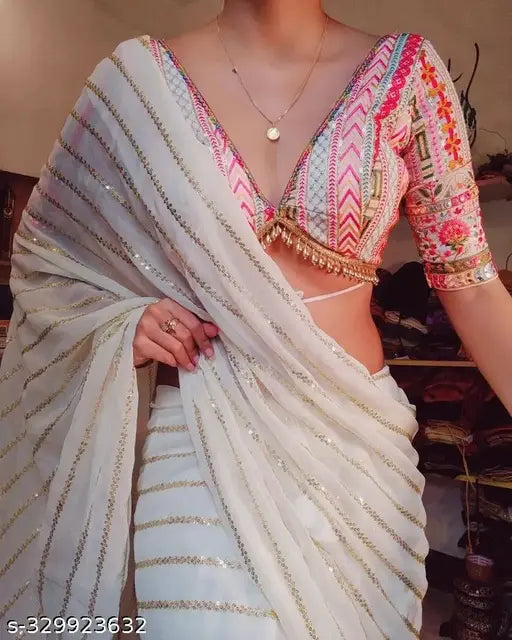Georgette sari with white design and sequence work, accompanied by a heavily embellished blouse