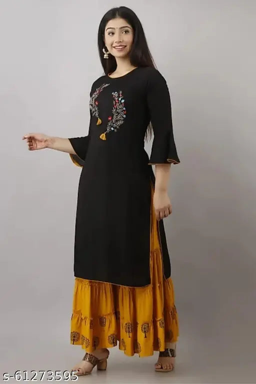 Woman in black kurta with flared bottoms and yellow dupatta