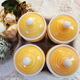 Yellow ceramic multipurpose storage containers in a set of four, each with a lid and placed on a tray, 500ml capacity, 4 inch diameter