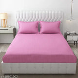 Premium pink satin stripe fitted bedsheet set, polycotton, stain resistant, breathable, hypoallergenic. Double bed (228 cm x 254 cm) with two pillow covers (46 cm x 68 cm). Ideal for summer use at home or hotels. Made in India