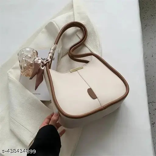 Tan leather shoulder bag with a small ribbon detail