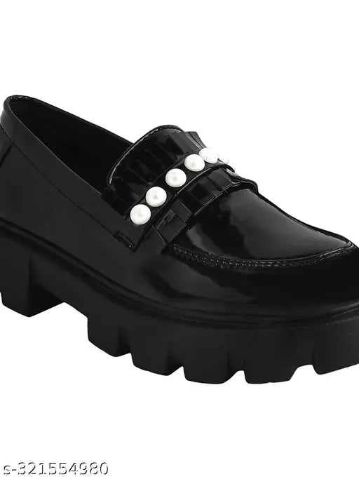 Detailed black synthetic loafers by Stylestry for women, featuring chain detailing and slip-on design, perfect for work or weekends