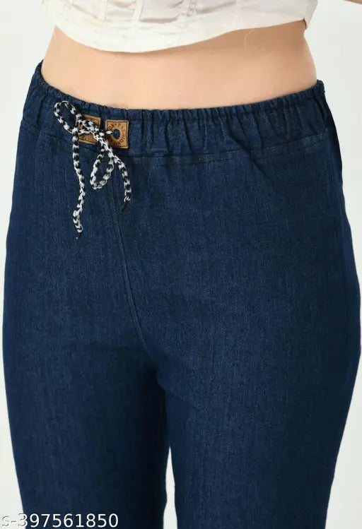 A pair of stretchable dark blue flared jogger jeans with a premium denim material, featuring an elastic waistband and ankle cuffs, in a mid-waist design