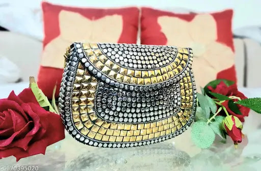 This is a sling bag with gold and silver accents, designed in the style of PARATO. The bag appears to be made of metal with stitching details that contribute to its elegant appearance. It has a large central compartment that is closed with what seems to be a lock or latch mechanism. The bag may include pockets or compartments that are not visible in this image. This sling bag could be suitable for parties, nightlife events, or as a stylish everyday carryall