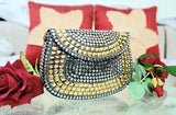 This is a sling bag with gold and silver accents, designed in the style of PARATO. The bag appears to be made of metal with stitching details that contribute to its elegant appearance. It has a large central compartment that is closed with what seems to be a lock or latch mechanism. The bag may include pockets or compartments that are not visible in this image. This sling bag could be suitable for parties, nightlife events, or as a stylish everyday carryall