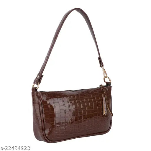 This is an image of a brown sling bag with adjustable straps, suitable for women. It has one main compartment and a smaller zippered pocket on the front. The bag appears sturdy and well-crafted, likely made from leather or similar material, and it could be used for casual outings or college classes