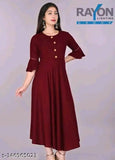 Maroon rayon round neck kurti for women & girls, casual & party wear under 300 Rs. Single color, three-quarter sleeves style. Model in size small, suitable for wedding/festivals with churidar or palazzo pants. Indian origin