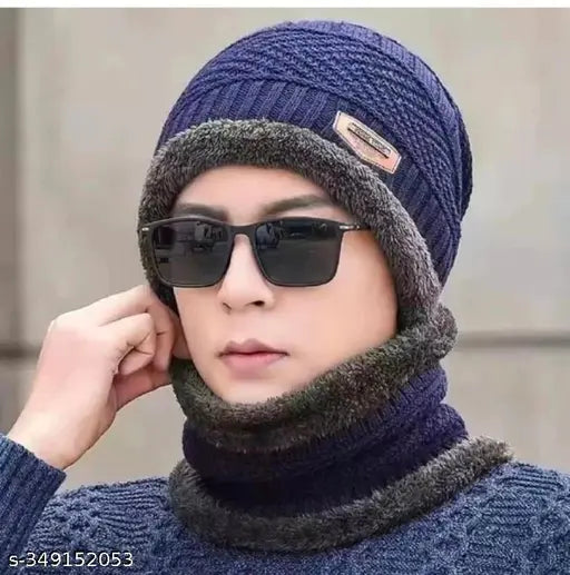 The image features a person wearing a navy blue beanie hat with a fur trim, paired with a pair of black sunglasses