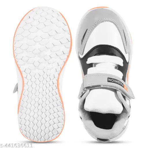 Black and white boys gym shoes with orange logo