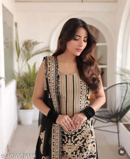 Stylish kurta set, black and gold design on a woman in a room