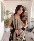 Stylish kurta set, black and gold design on a woman in a room