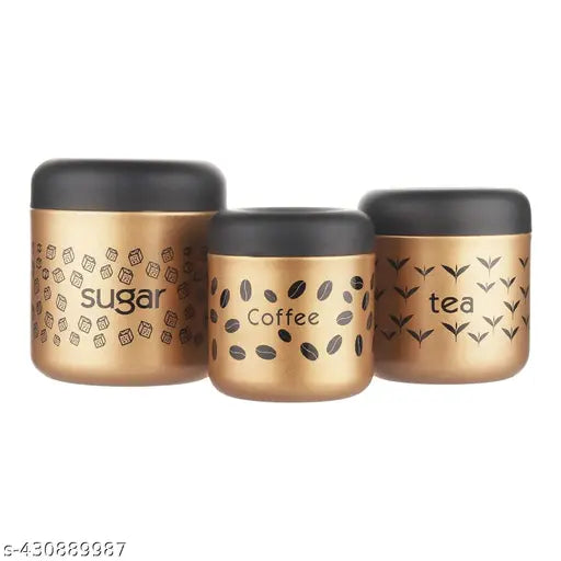 Black and gold stainless steel canister set. Contains three canisters with gold print and color coating for coffee, tea, and sugar. Matte finish. Each jar is 700ml, 500ml, and 300ml