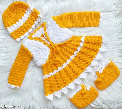 Handcrafted acrylic baby girl woolen frock/sweater with cap and booties in vibrant yellow and white, featuring intricate crochet patterns and scalloped trims. Perfect for special occasions or everyday wear, sizes 6-12 months, 9-12 months, 12-18 months. Made in India
