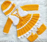 Handcrafted acrylic baby girl woolen frock/sweater with cap and booties in vibrant yellow and white, featuring intricate crochet patterns and scalloped trims. Perfect for special occasions or everyday wear, sizes 6-12 months, 9-12 months, 12-18 months. Made in India