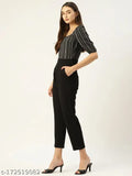 Black & White striped crepe jumpsuit by Magnetic Designs, short sleeves and solid net pattern. Accessible fashion for women, available in sizes S, L, XL. Model shown wears size L. Made in India