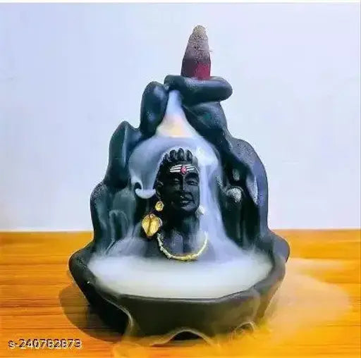 Black polyresin Shiv backflow incense burner with 10 cones, featuring Lord Shiva meditating beside a smokey waterfall illusion. Handcrafted Indian artwork for home decor