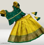 Vibrant silk lehenga, Festive South Indian wear, adorned with intricate zari work & embroidery" (102 characters)