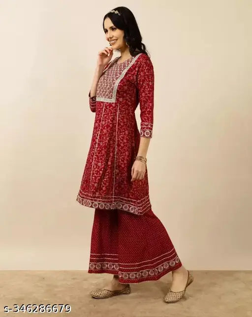 A vibrant red kurta sharara dupatta set with traditional embroidery